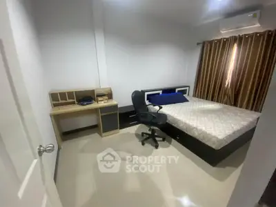 Modern bedroom with sleek furniture and natural light, perfect for comfort and relaxation.