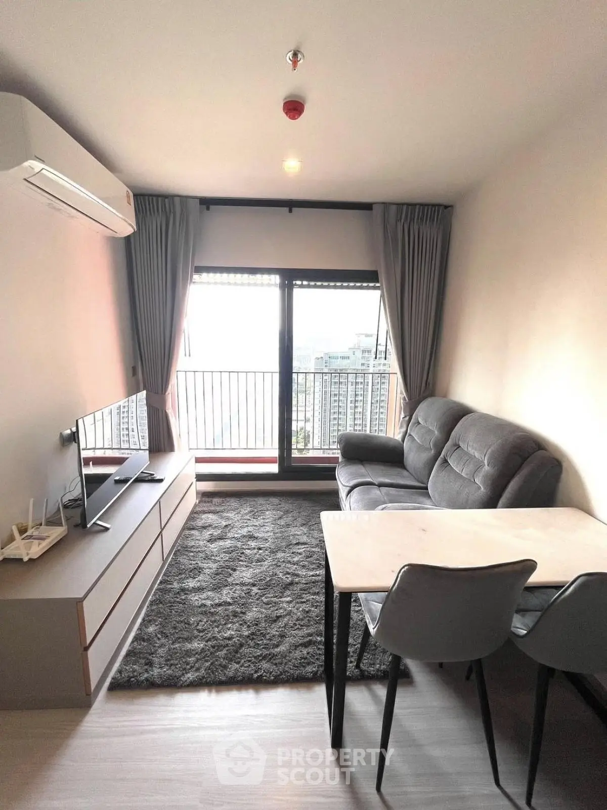 Modern living room with balcony view in high-rise apartment