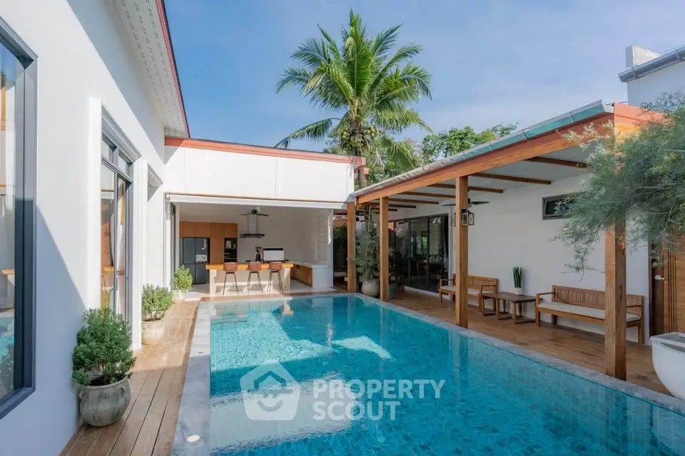 Luxurious modern villa with private pool and outdoor seating area, perfect for tropical living.