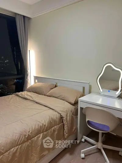 Cozy bedroom with elegant vanity and city view, perfect for urban living.