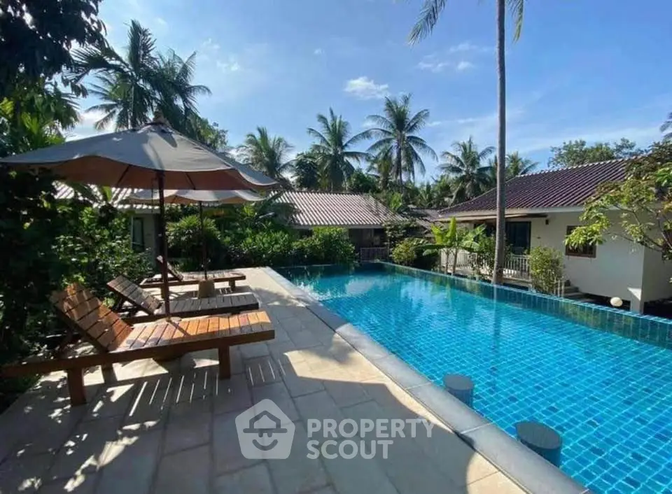 Luxurious tropical villa with stunning pool and lush garden setting.