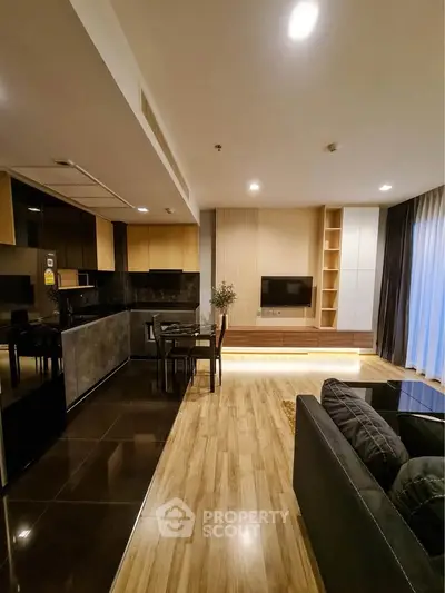 Modern open-layout living room with sleek kitchen and stylish decor