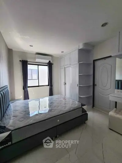 Modern bedroom with sleek design and ample natural light