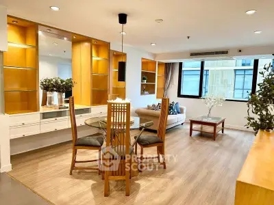 Spacious living room with elegant wooden furniture and large windows in modern apartment.
