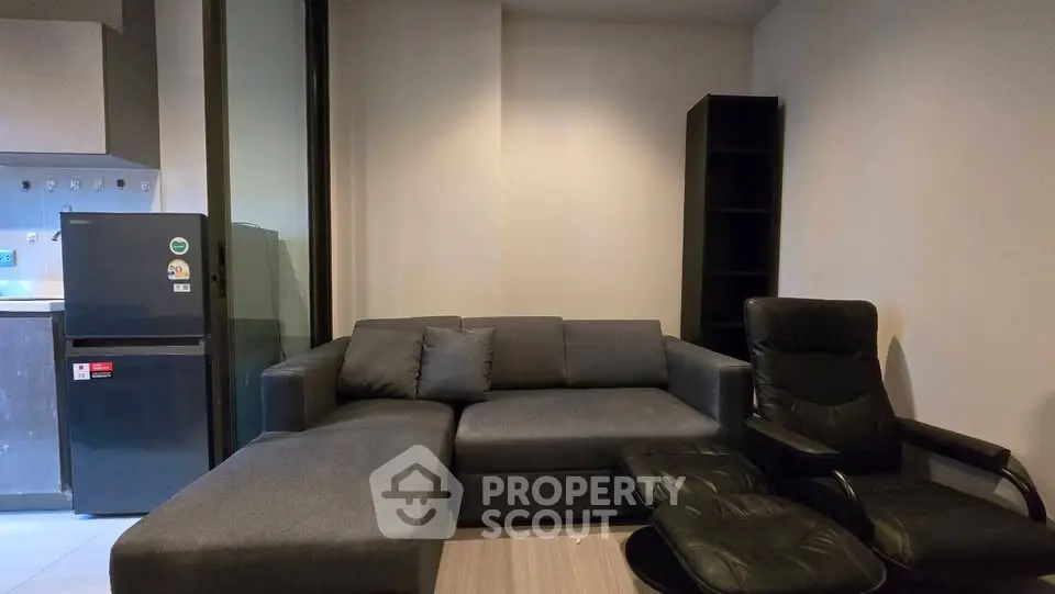 Modern living room with sleek furniture and open kitchen layout