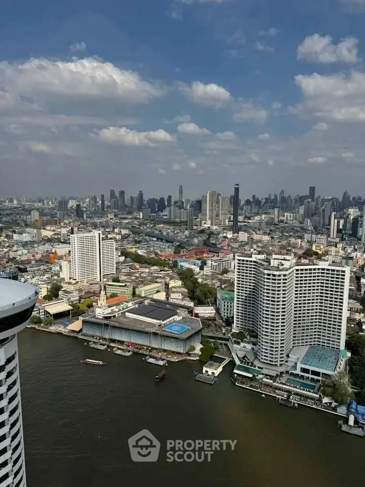 Stunning cityscape view from high-rise building overlooking river and skyline, perfect for urban living enthusiasts.