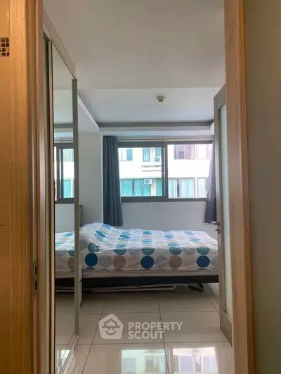 Cozy bedroom with large window and modern decor in urban apartment