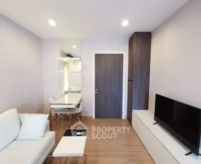Modern living room with sleek furniture and stylish decor in a contemporary apartment.