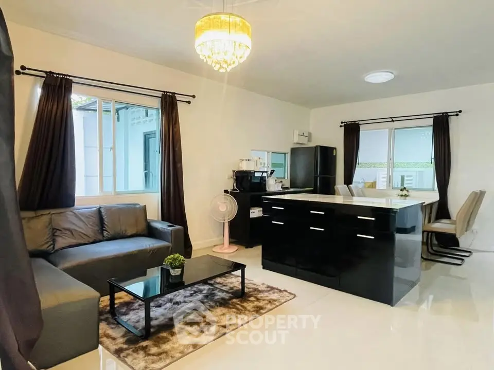 Modern open-plan living room with sleek kitchen and stylish decor