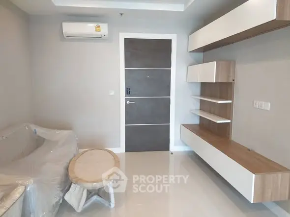 Modern living room with sleek furniture and air conditioning unit