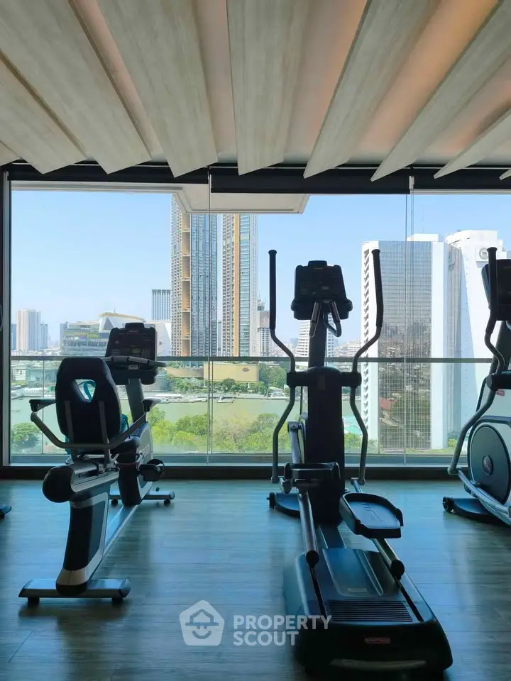 Modern gym with city view and state-of-the-art fitness equipment in luxury building.