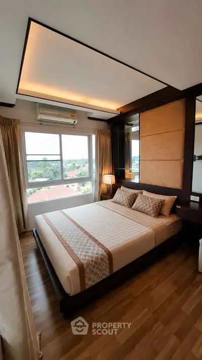 Luxurious bedroom with modern design and large window offering scenic views