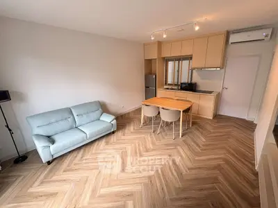 Modern living room with stylish herringbone flooring and cozy furniture