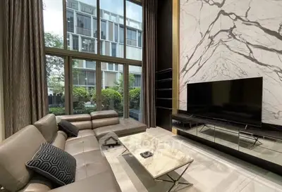 Luxurious living room with marble accent wall and modern furniture