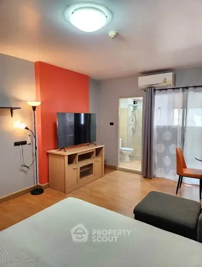 Modern studio apartment with open layout, featuring a cozy living area and stylish decor.