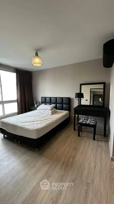 Spacious bedroom with modern decor and natural light