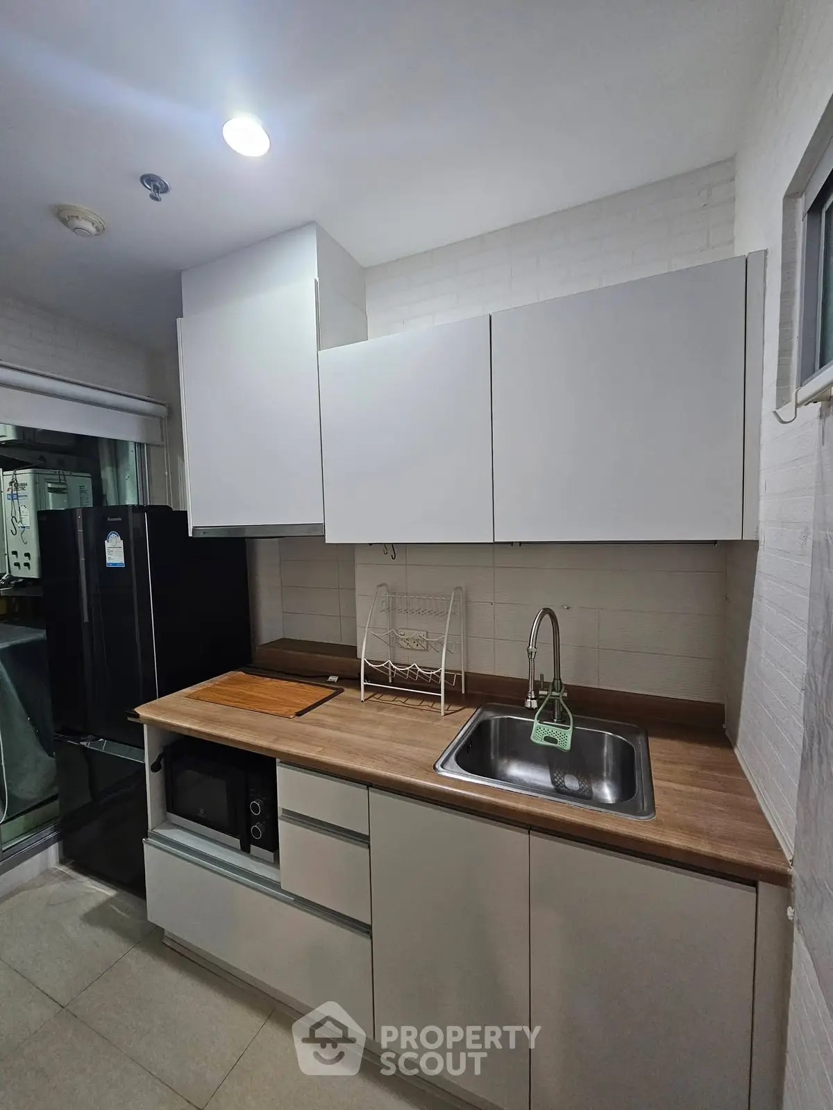 Modern kitchen with sleek cabinetry and stainless steel sink