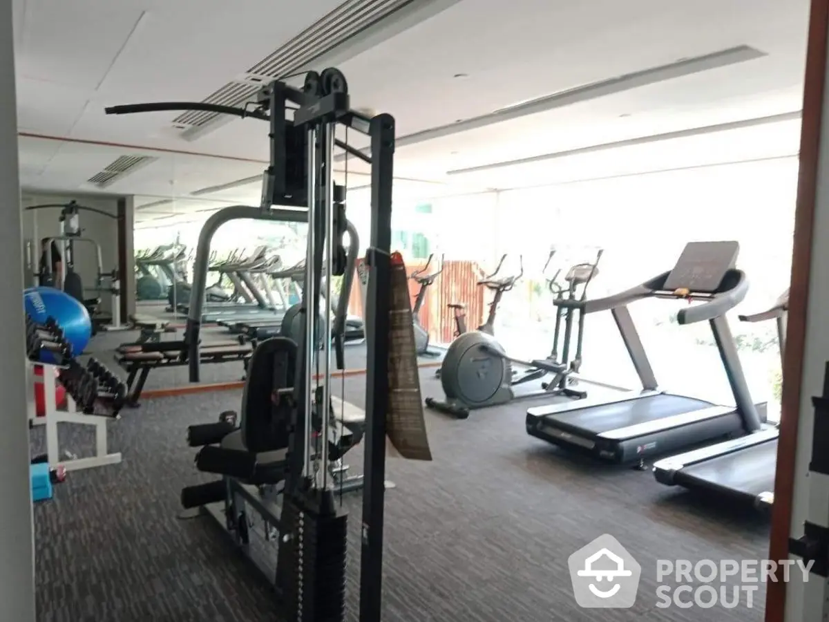 Modern gym with state-of-the-art fitness equipment in luxury apartment building