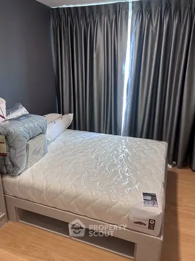 Cozy bedroom with modern decor and ample natural light, featuring a comfortable bed and stylish curtains.
