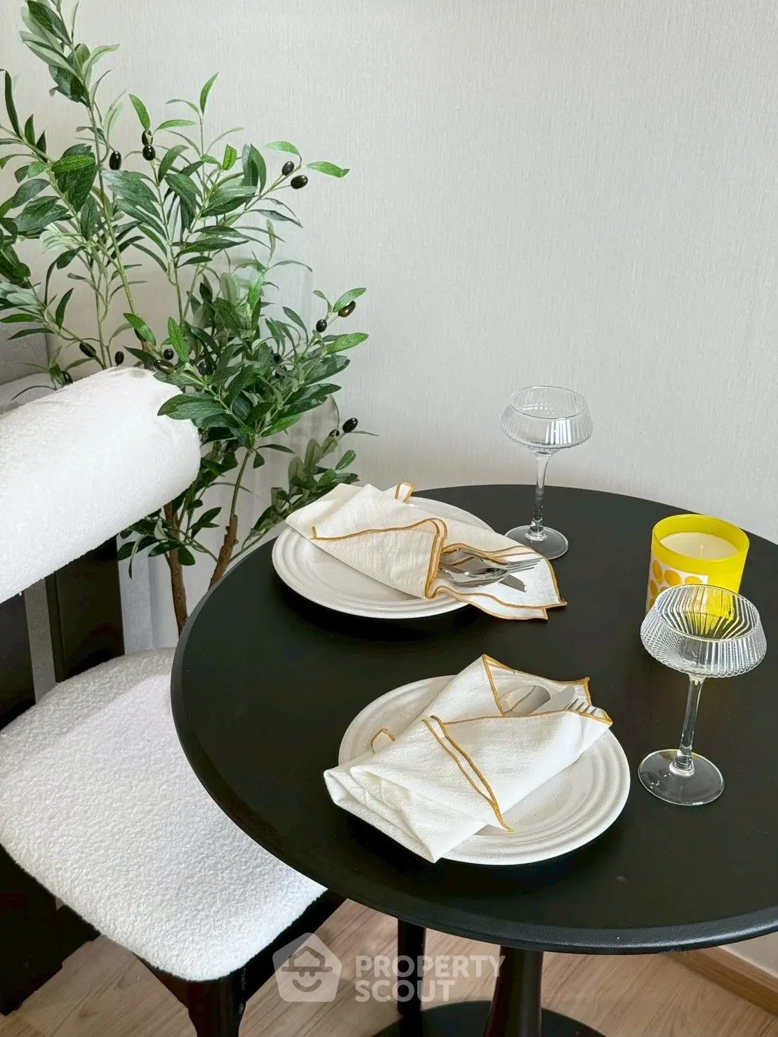 Cozy dining nook with elegant table setting and lush plant decor