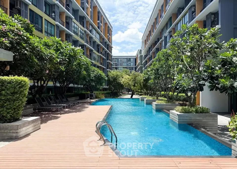 Luxurious condominium with stunning pool and lush greenery, perfect for relaxation and modern living.