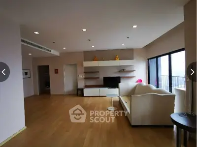 Spacious living room with modern decor and large windows for natural light.