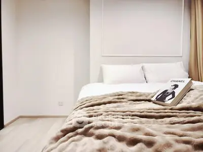 Cozy bedroom with plush bedding and stylish decor, perfect for relaxation.