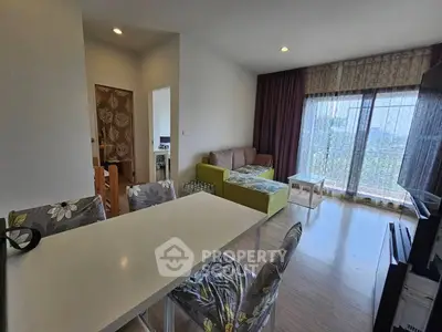 Spacious living room with modern decor and large windows offering natural light