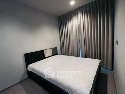 Modern bedroom with sleek design and cozy ambiance, featuring a comfortable bed and elegant curtains.