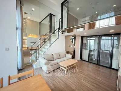 Modern duplex living room with high ceilings and stylish staircase