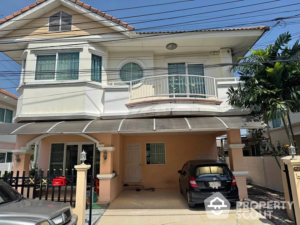 Charming two-story house with carport and balcony in a serene neighborhood.