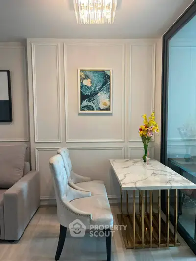 Elegant living room with chic marble table and plush chairs, perfect for modern urban living.