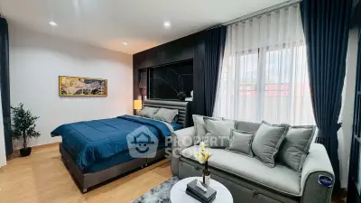 Luxurious bedroom with elegant decor and cozy seating area, perfect for relaxation and comfort.
