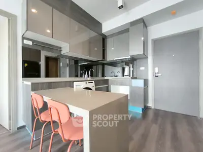 Modern kitchen with sleek cabinetry and dining area in contemporary apartment