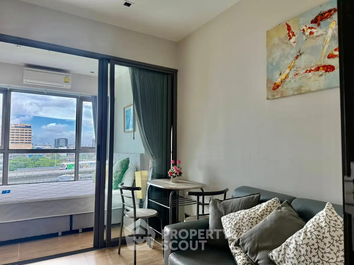 Modern living room with glass partition and city view, featuring cozy seating and stylish decor.