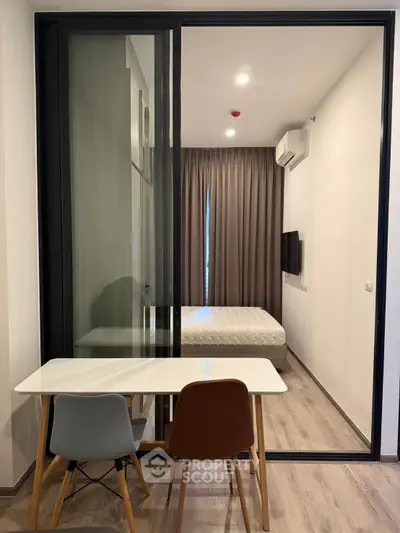 Modern studio apartment with glass partition and minimalist decor