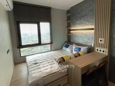 Modern bedroom with city view, featuring stylish decor and ample natural light.