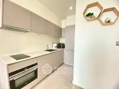 Modern kitchen with sleek cabinetry and built-in appliances in a bright, minimalist design.