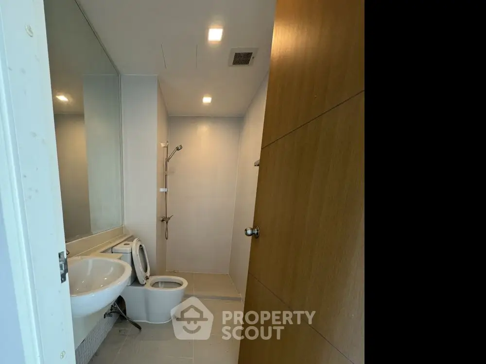 Modern bathroom with sleek fixtures and spacious shower area