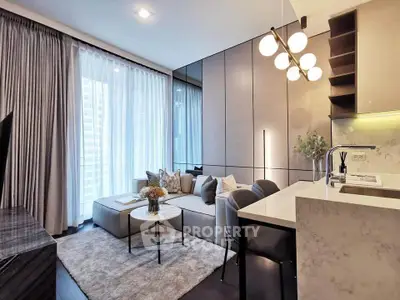Modern living room with elegant decor and open kitchen layout in a stylish apartment.