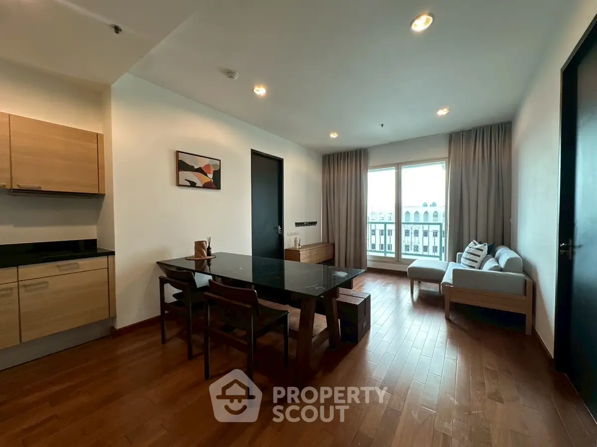 Spacious modern living room with wooden flooring and elegant dining area