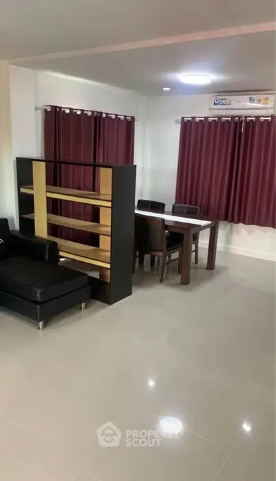 Modern living room with sleek furniture and dining area, featuring elegant curtains and glossy flooring.