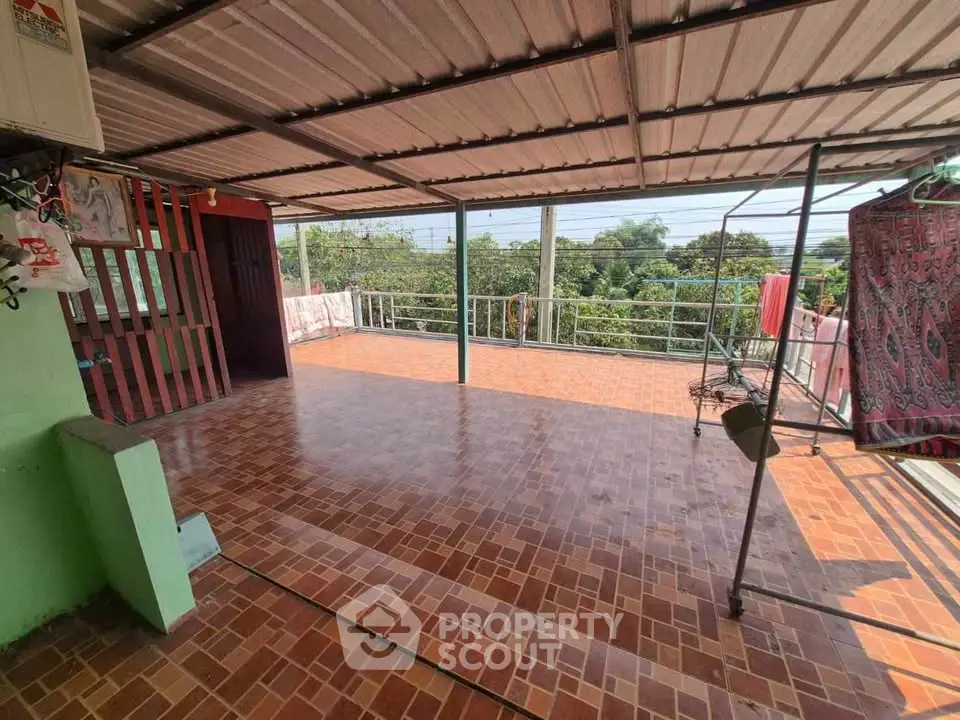 Spacious rooftop terrace with tiled flooring and scenic views, perfect for outdoor relaxation and gatherings.