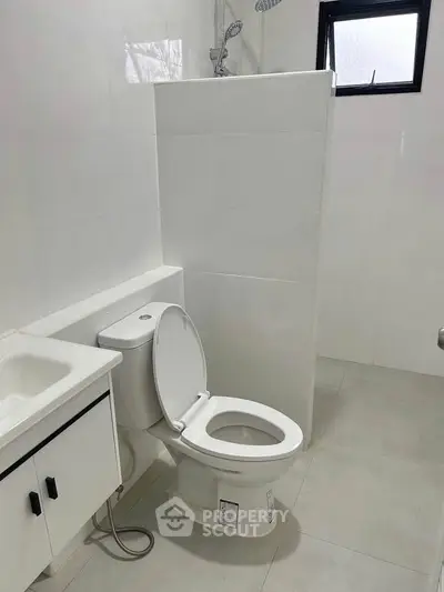 Modern bathroom with sleek white tiles and contemporary fixtures