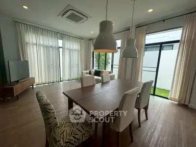 Spacious living room with elegant dining area and natural light