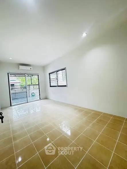 Spacious unfurnished room with large windows and tiled floor, perfect for customization.