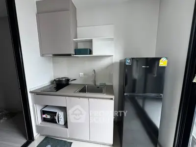 Modern compact kitchen with sleek appliances and minimalist design, perfect for urban living.