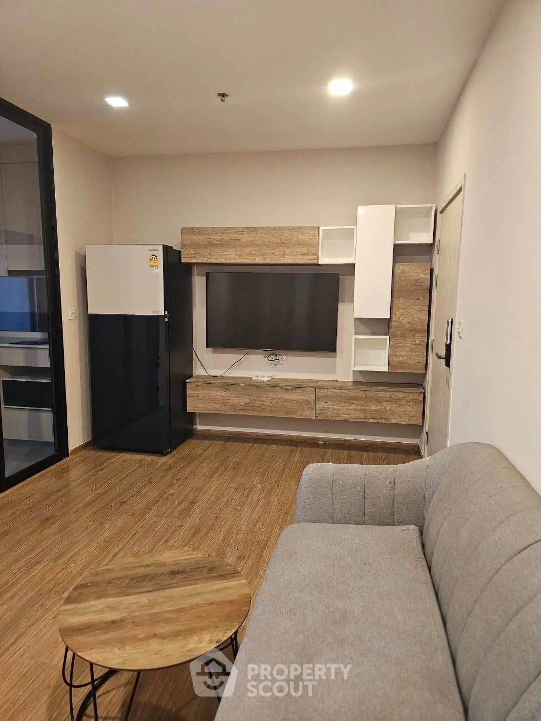 Modern living room with sleek furniture and wooden flooring