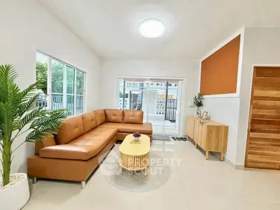 Modern living room with stylish brown leather sofa and natural wood accents, perfect for cozy gatherings.