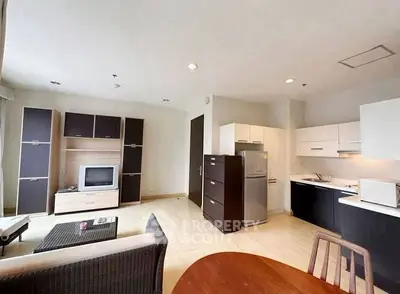 Spacious open-layout living room with modern kitchen and stylish furniture in a contemporary apartment.
